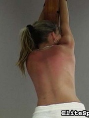 Reddened and painful, her back shows the - Unique Bondage - Pic 10