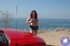 Bbw porn. Busty redhead flashes her tits to the ocean.
