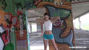 Sporty college girl rubs herself under a viaduct