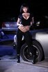 Tattooed brunette scissoring with busty blondie on the car