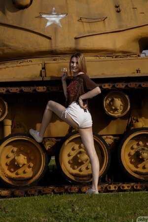 Naughty long-haired cutie enjoys visiting military machinery museum