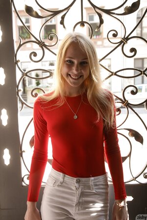 Hot blonde teen enjoys showing her sexy red bodysuit
