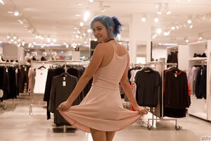 Naughty young chick shows her boobs and butt in the store