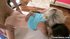 Oiled up asses are bouncing on a fat cock in a threesome
